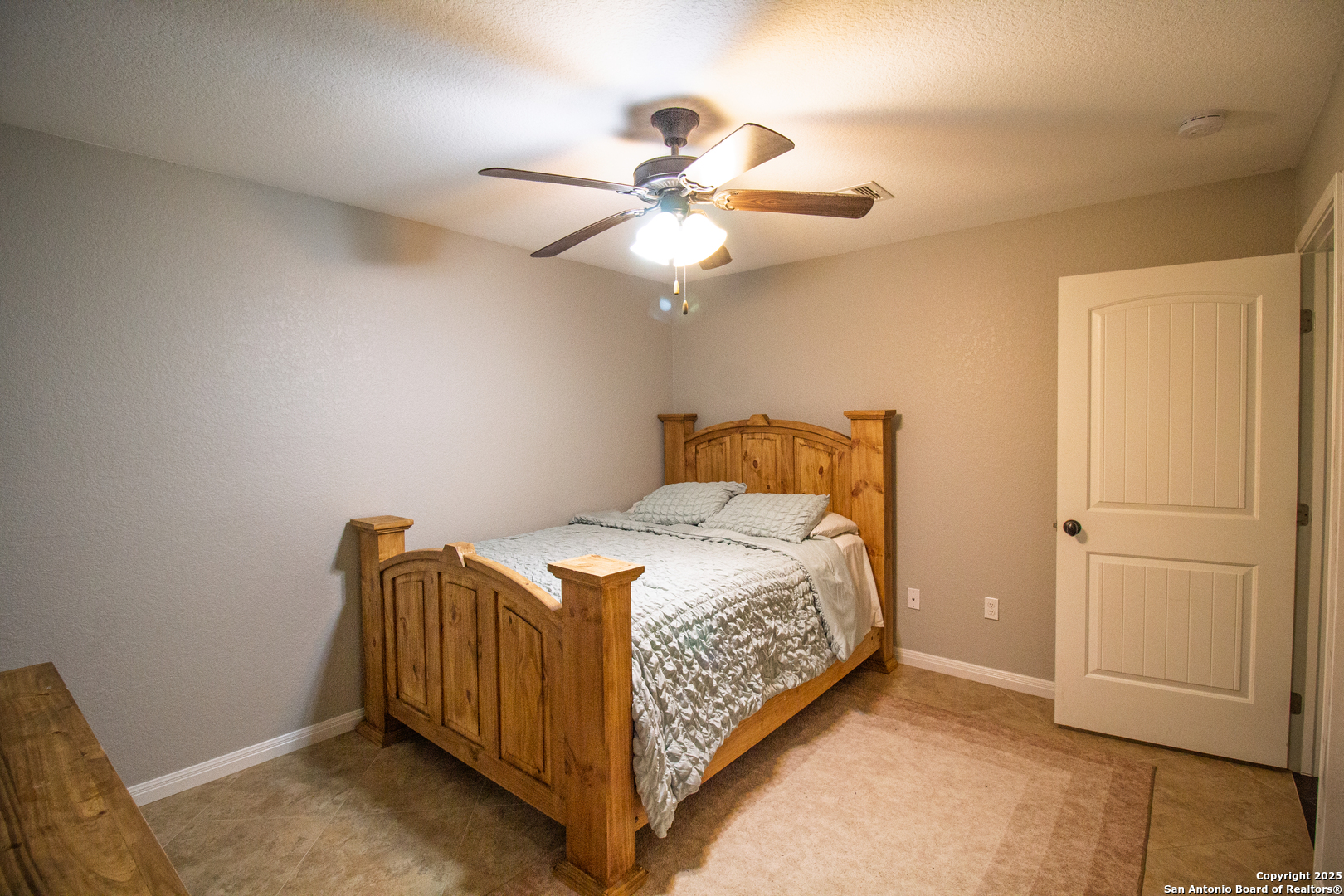 504 West Sullivan Street Skidmore, TX 78389 - Photo 26 of 35 a bedroom with a bed and a ceiling fan