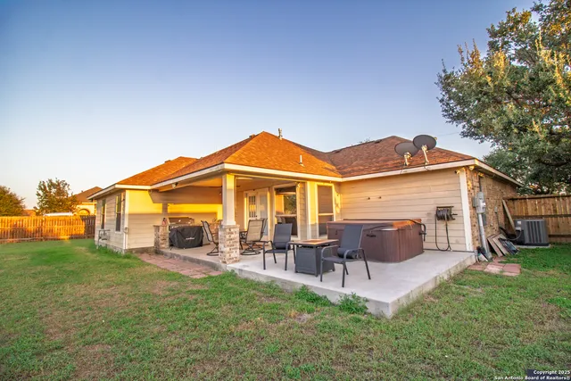 a view of a house with a backyard and a patio