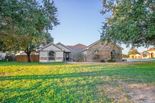 a front view of house with yard and green space