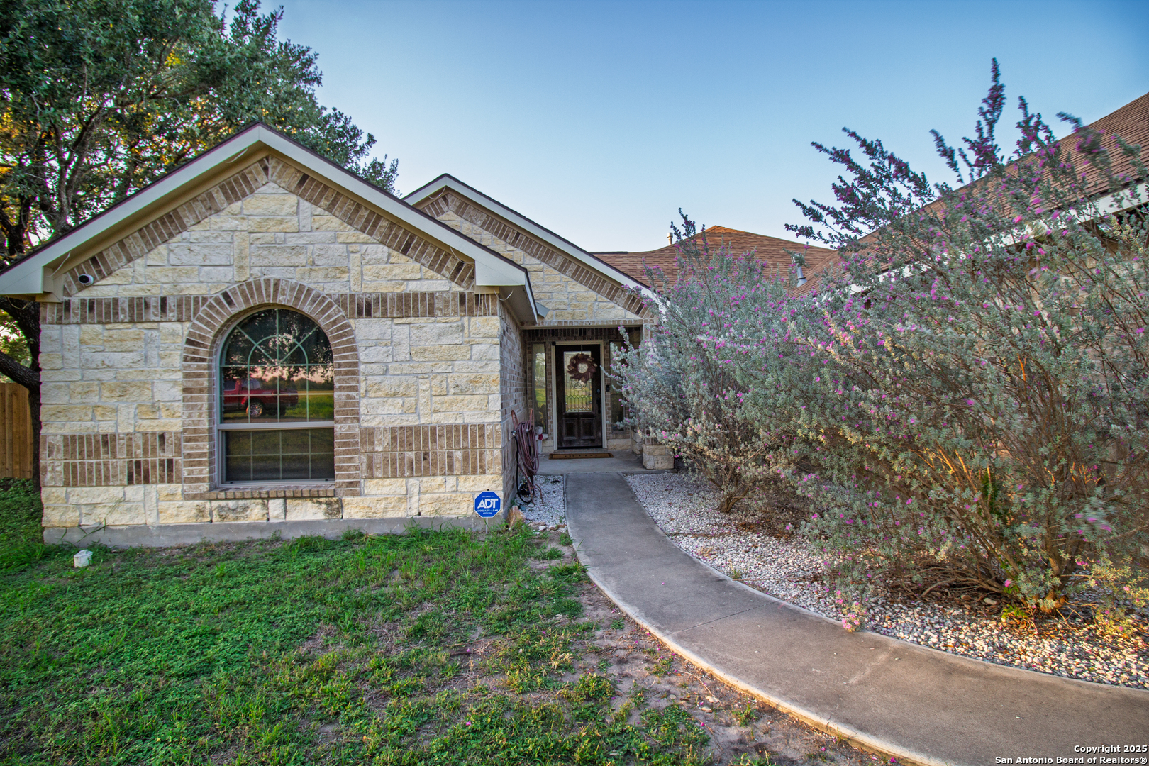 504 West Sullivan Street Skidmore, TX 78389 - Photo 6 of 35 a front view of a house with garden