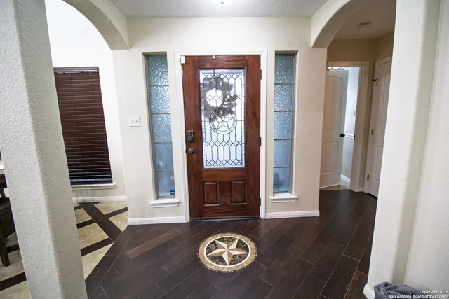 a view of an entryway with wooden floor
