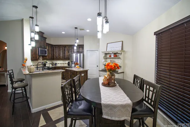 a view of a dining room with furniture and a chandelier