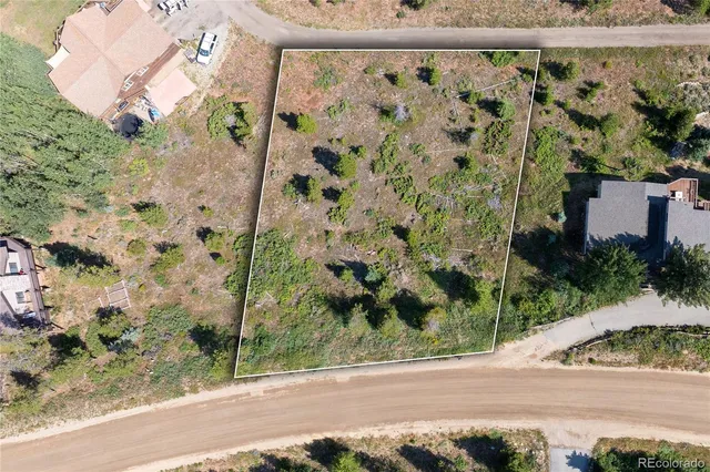 a view of a yard with a wooden fence