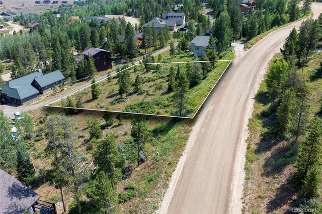 a view of a garden with a building in the background