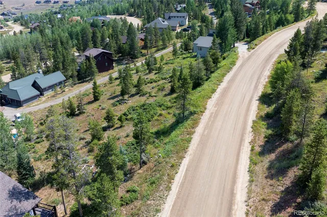 a view of a city with lush green forest