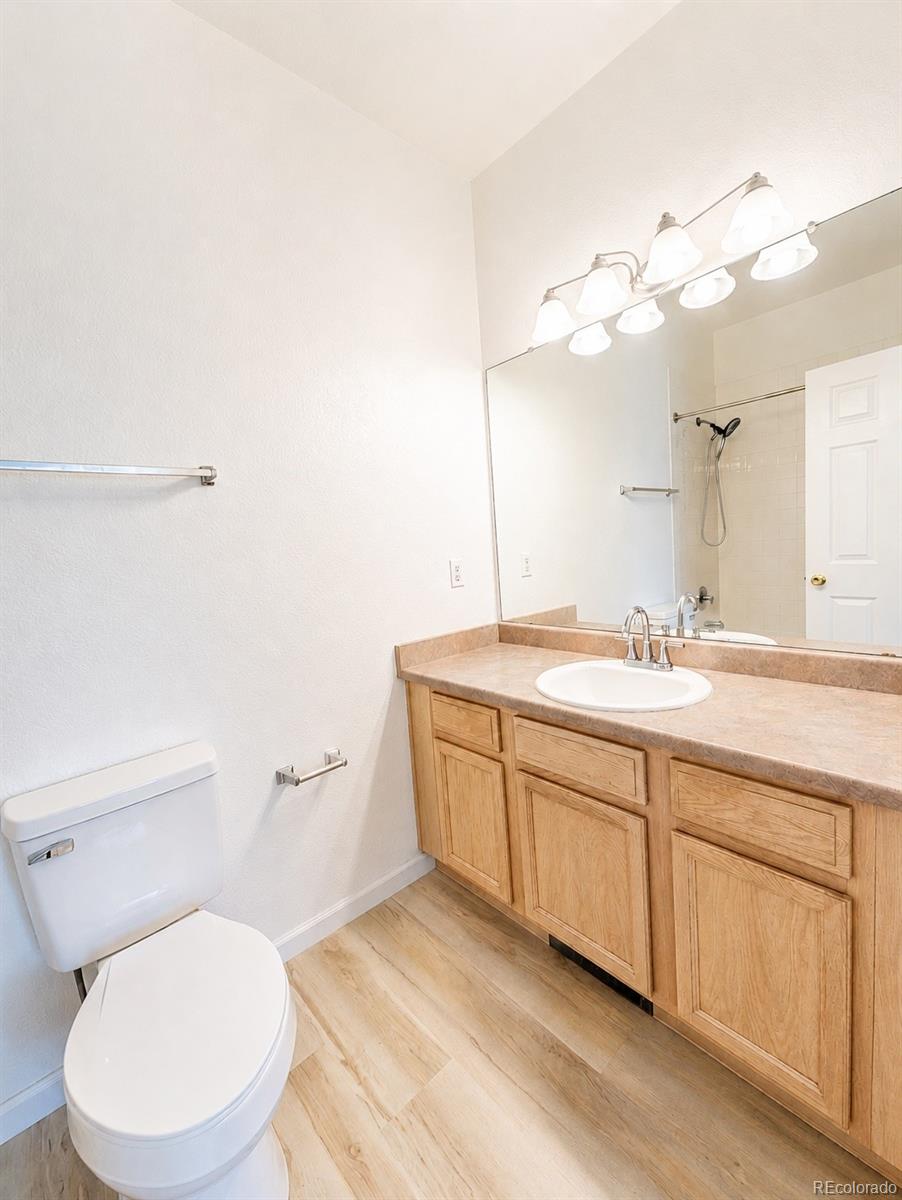 8199 Welby Road, Unit 4301 Denver, CO 80229 - Photo 11 of 19 a bathroom with a toilet a sink and mirror