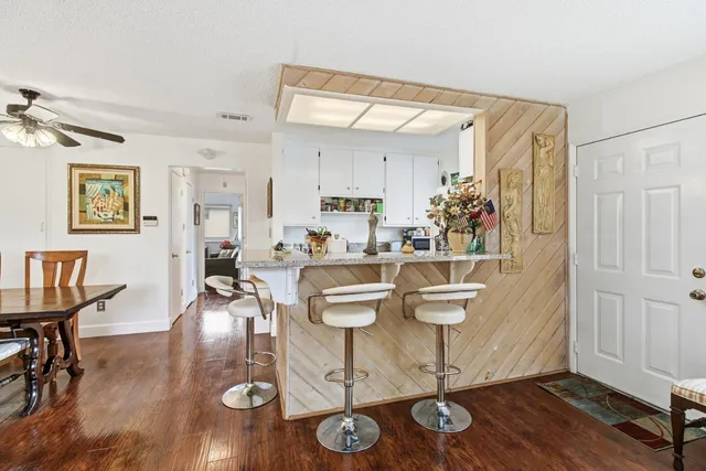 a dining room with wooden floor and glass table