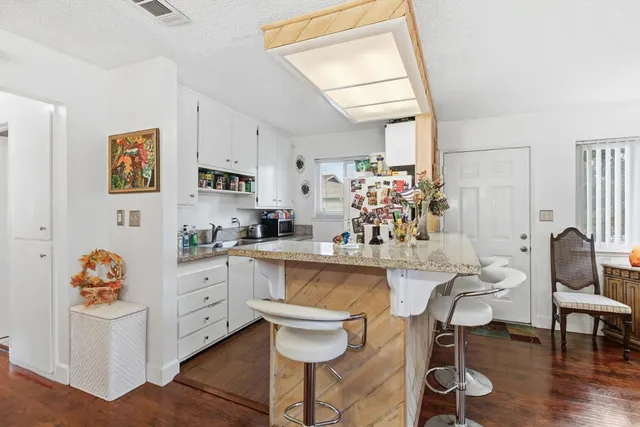 a kitchen with a sink cabinets and window