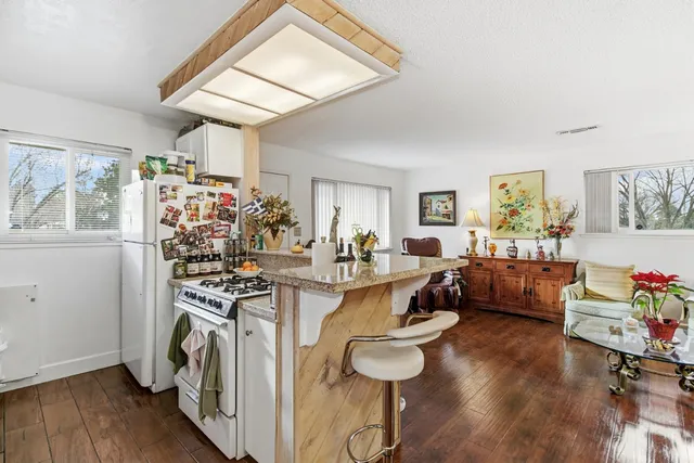 a kitchen with stainless steel appliances granite countertop a stove and a sink