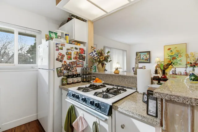 a kitchen with stainless steel appliances granite countertop a sink stove and cabinets