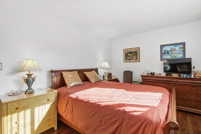 a bed room with two bed and a lamp