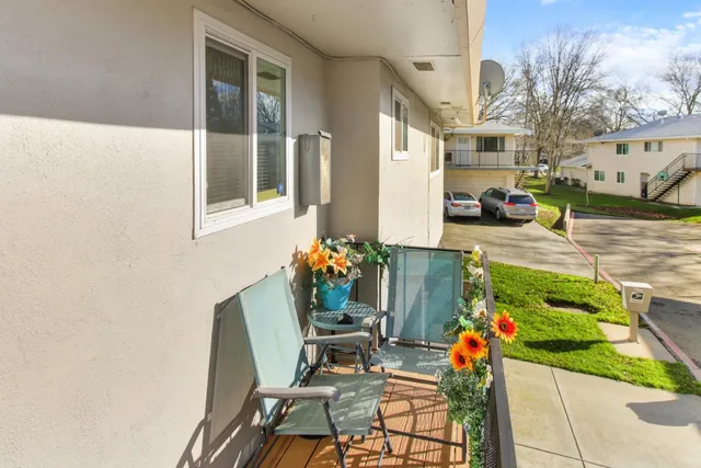 a front view of a house with a garden and plants