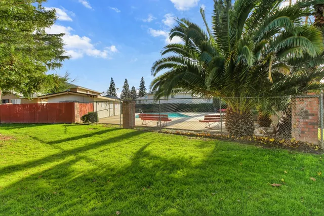 a backyard of a house with table and chairs