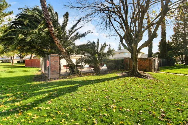 a view of a backyard and swimming pool