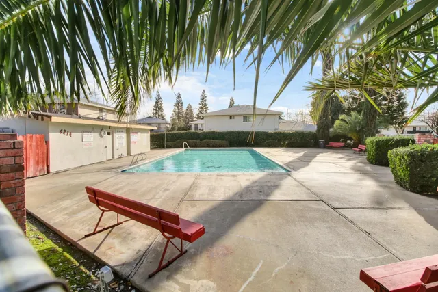 a front view of a house with a garden and yard