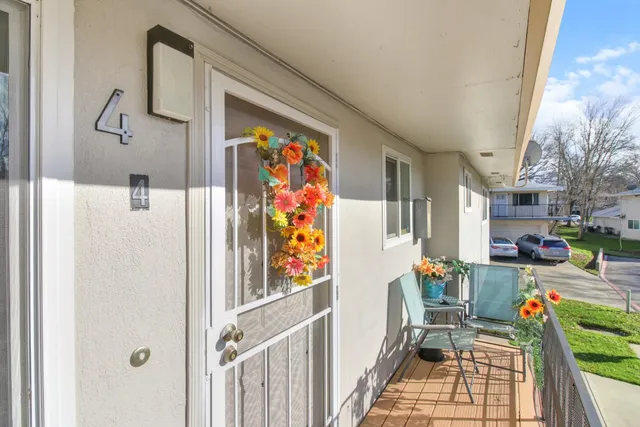 a view of a hallway with a dining table and chairs