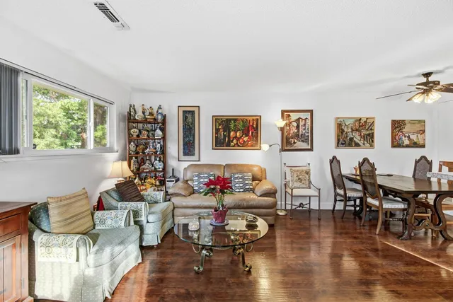 a living room with fireplace furniture and a large window