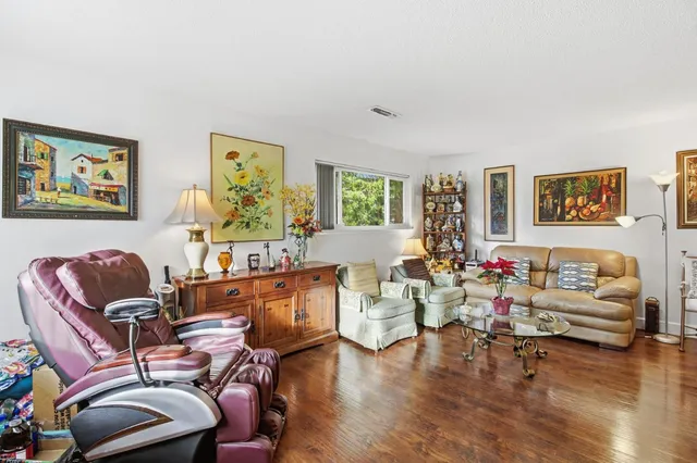 a living room with furniture or couch and a wooden floor