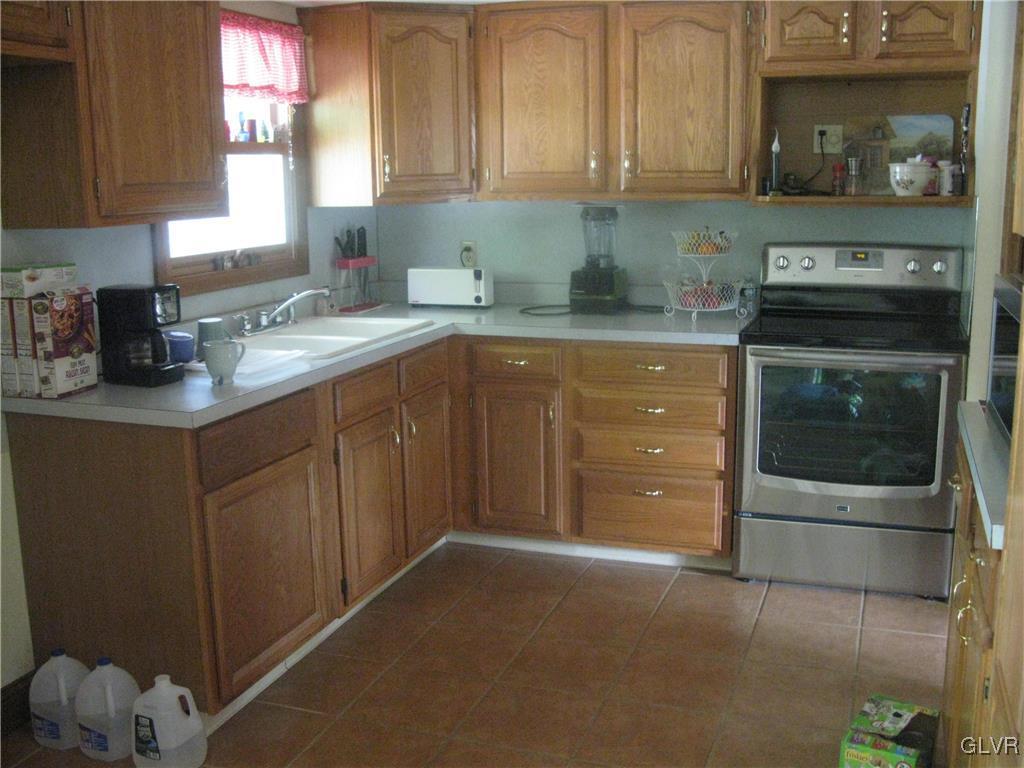 616 South Summit Road Bath, PA 18014 - Photo 13 of 22 a kitchen with granite countertop cabinets stainless steel appliances and a counter space