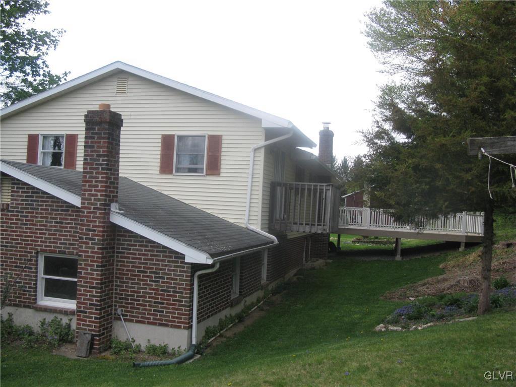616 South Summit Road Bath, PA 18014 - Photo 9 of 22 a view of backyard of house with wooden deck and trees