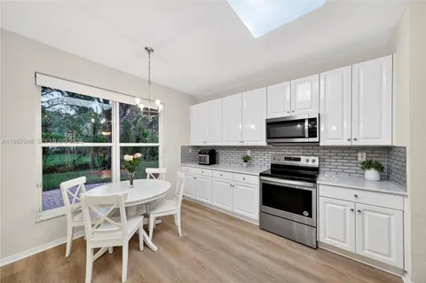 a front view of a house with a garden and plants