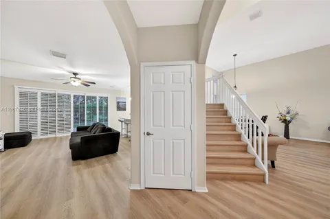 a view of a dining room with furniture large window and wooden floor