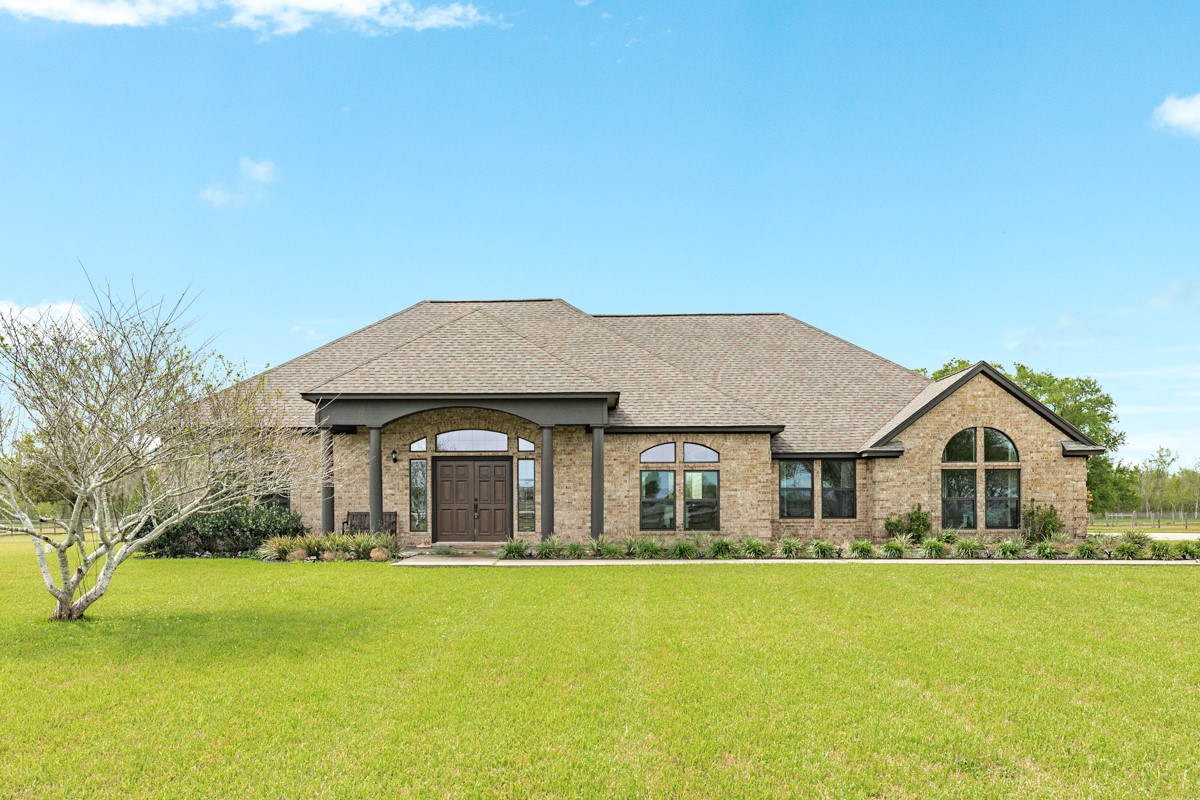 20111 Farm To Market Road 523 Angleton, TX 77515 - Photo 12 of 47 a front view of a house with a garden