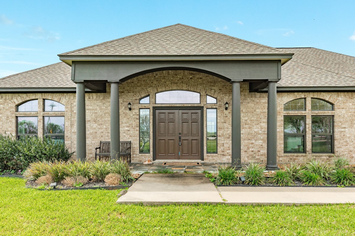 20111 Farm To Market Road 523 Angleton, TX 77515 - Photo 14 of 47 a front view of a house with garden