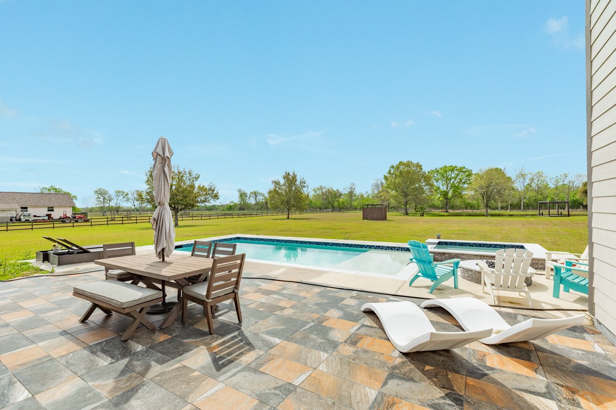 20111 Farm To Market Road 523 Angleton, TX 77515 - Photo 21 of 47 a view of swimming pool with outdoor seating space and garden