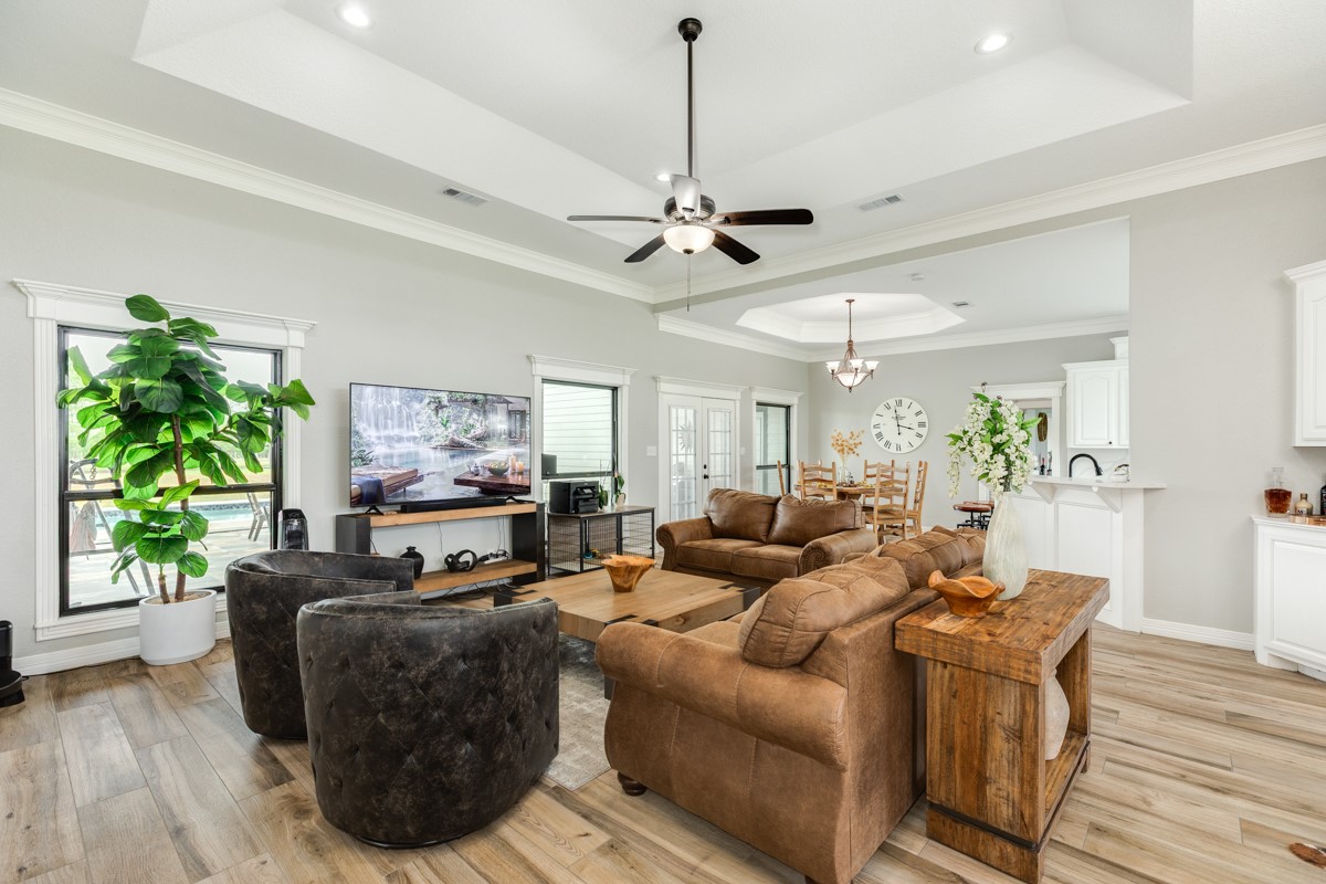 20111 Farm To Market Road 523 Angleton, TX 77515 - Photo 27 of 47 a living room with furniture a fireplace and a chandelier