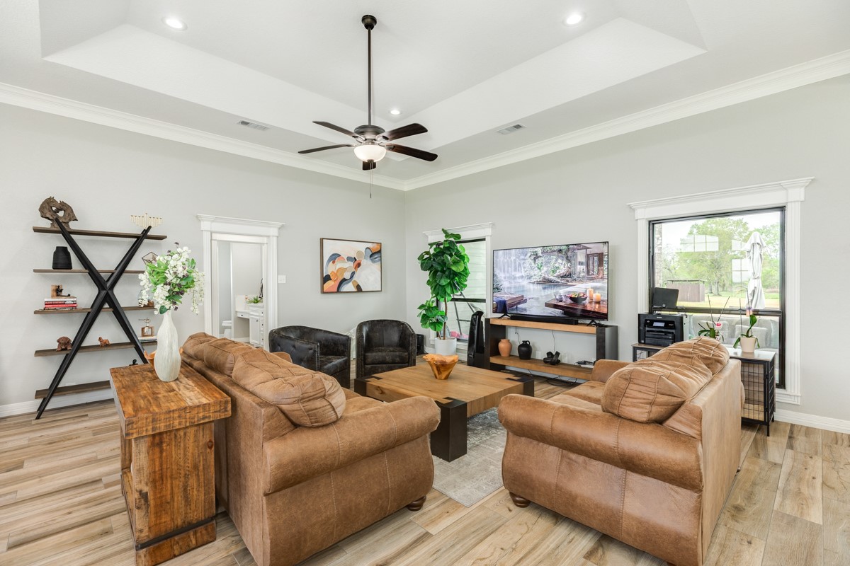 20111 Farm To Market Road 523 Angleton, TX 77515 - Photo 29 of 47 a living room with furniture a fireplace and a flat screen tv