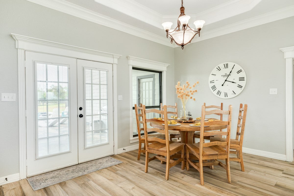 20111 Farm To Market Road 523 Angleton, TX 77515 - Photo 32 of 47 a view of a dining room with furniture wooden floor and a chandelier
