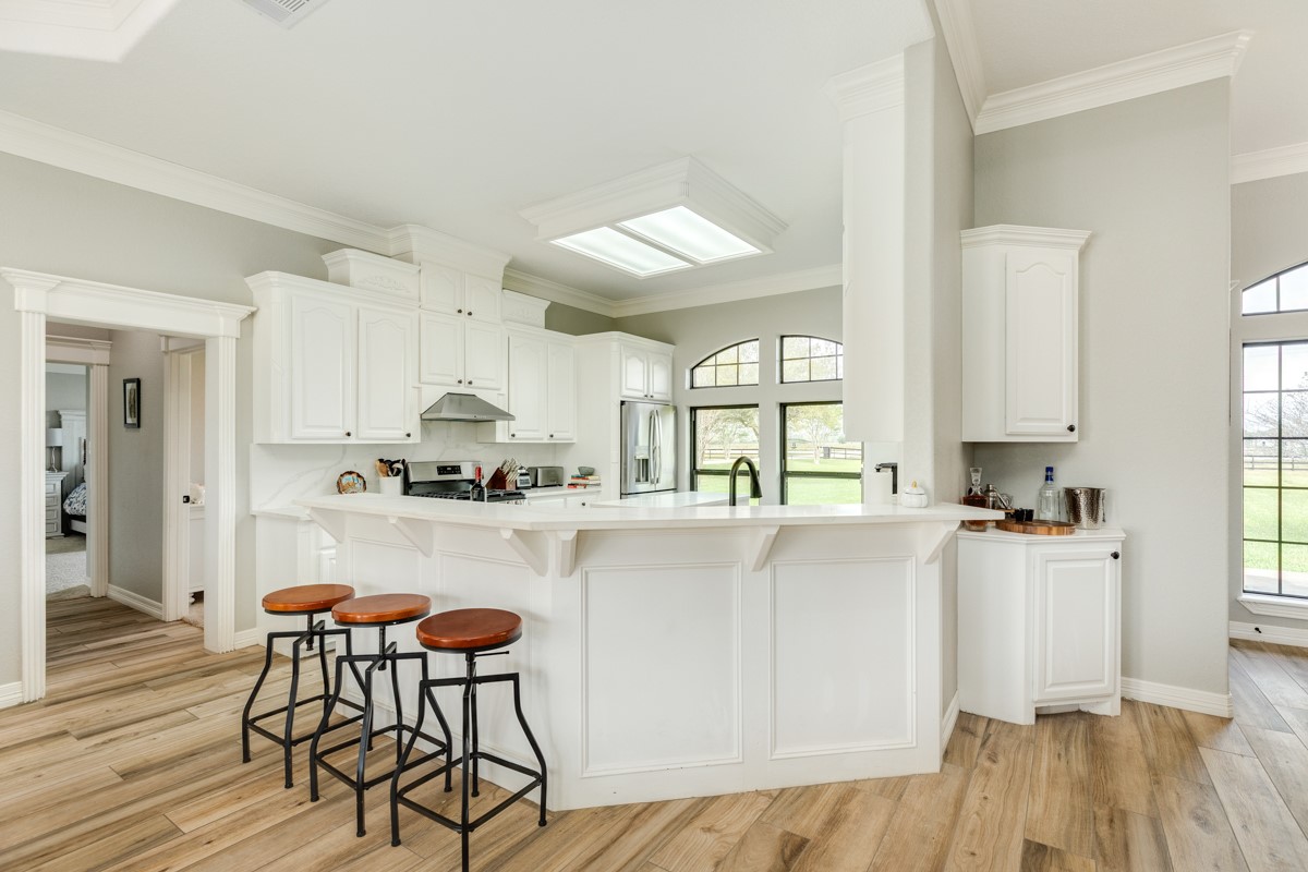 20111 Farm To Market Road 523 Angleton, TX 77515 - Photo 33 of 47 a kitchen with stainless steel appliances a table and chairs in it