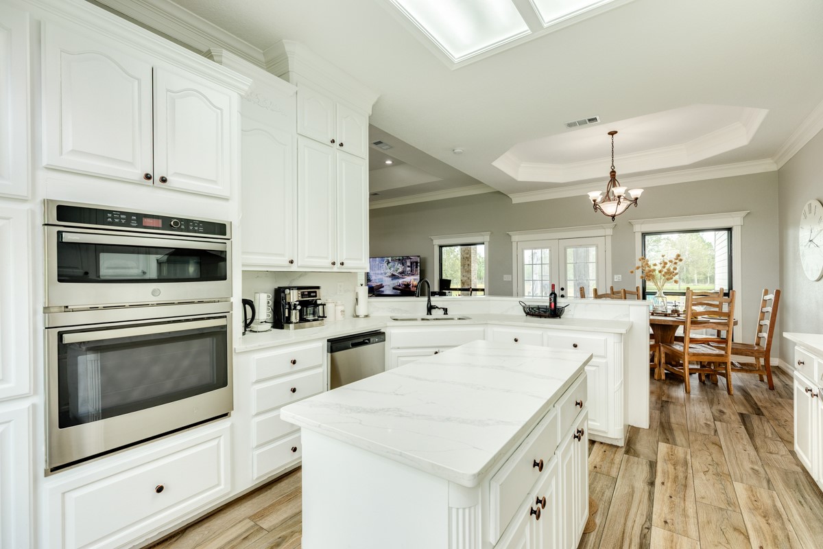 20111 Farm To Market Road 523 Angleton, TX 77515 - Photo 37 of 47 a kitchen with a stove white cabinets and white appliances