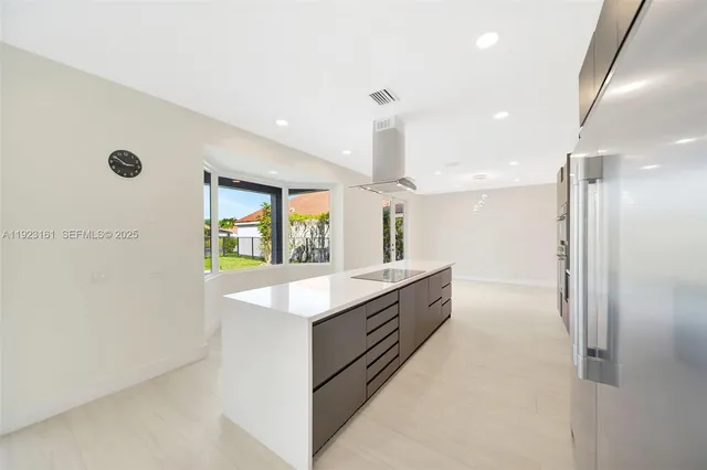a large kitchen with a lot of counter space and stainless steel appliances
