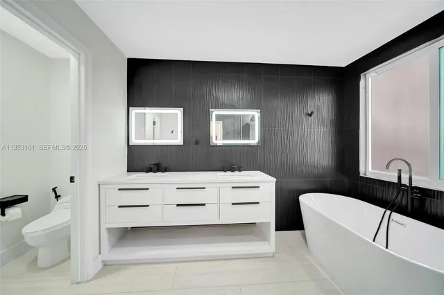 a bathroom with a toilet a sink and a mirror