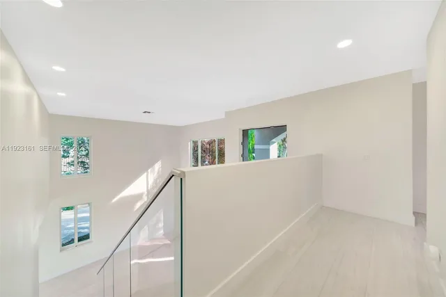 a view of room with window and hallway