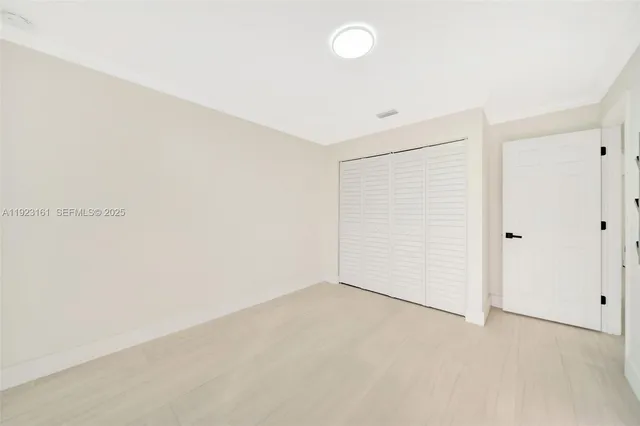 a view of hallway with furniture and a window