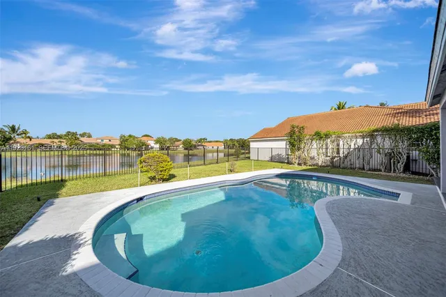 a view of a swimming pool with an outdoor seating