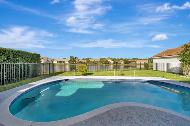a view of a swimming pool and a yard