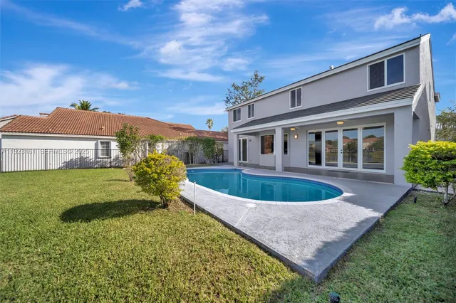 an aerial view of house with outdoor space swimming pool and mountains