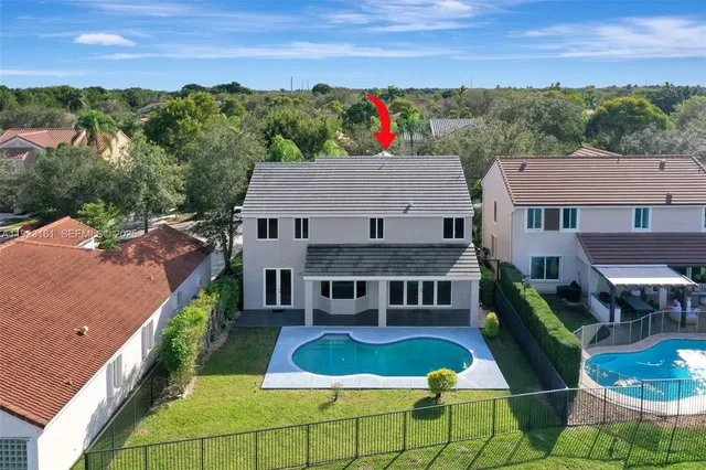 an aerial view of a house with a lake view