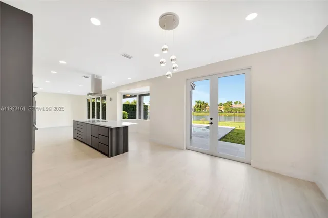 a view of kitchen with a refrigerator and a stove top oven