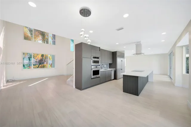 a view of kitchen with stainless steel appliances refrigerator and microwave