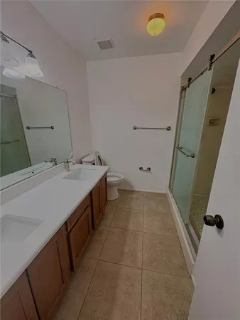 an empty room with wooden floor and closet