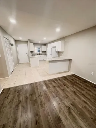 a view of a kitchen with a sink and wooden floor
