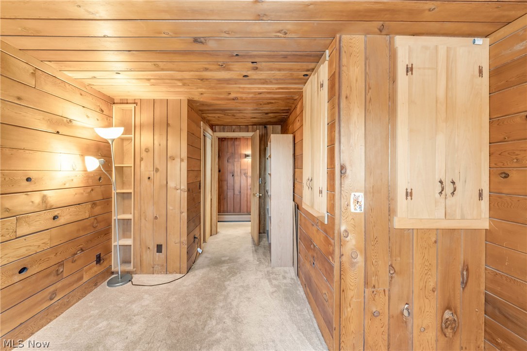 22791 Harms Road Euclid, OH 44143 - Photo 31 of 39 Corridor with wooden walls, wood ceiling, and light carpet