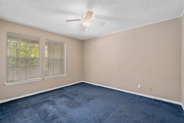 an empty room with a empty space and windows