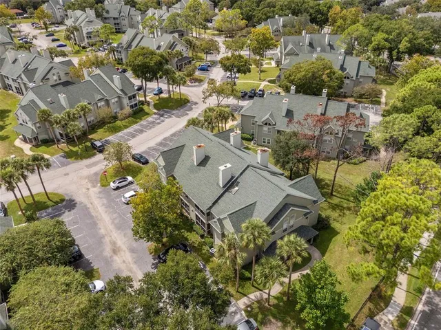 an aerial view of a house with a yard and lake view