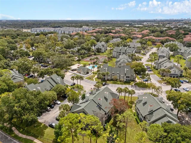 an aerial view of residential building with parking
